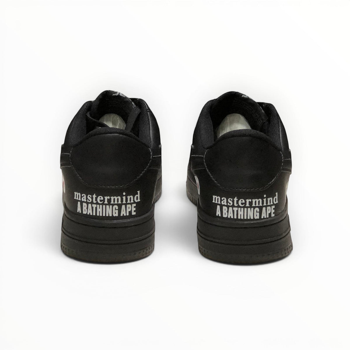 A Bathing Ape BAPE STA men's low-top sneakers in Triple Black, rear heel view