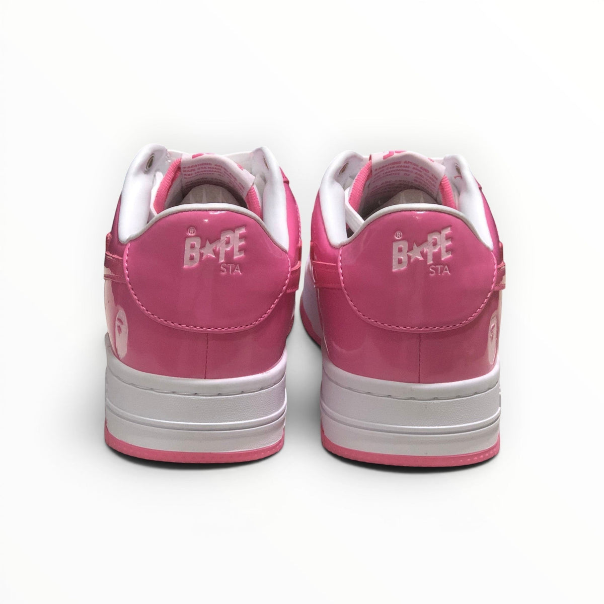 A Bathing Ape BAPE STA men's low-top sneakers in Pink/White, rear heel view