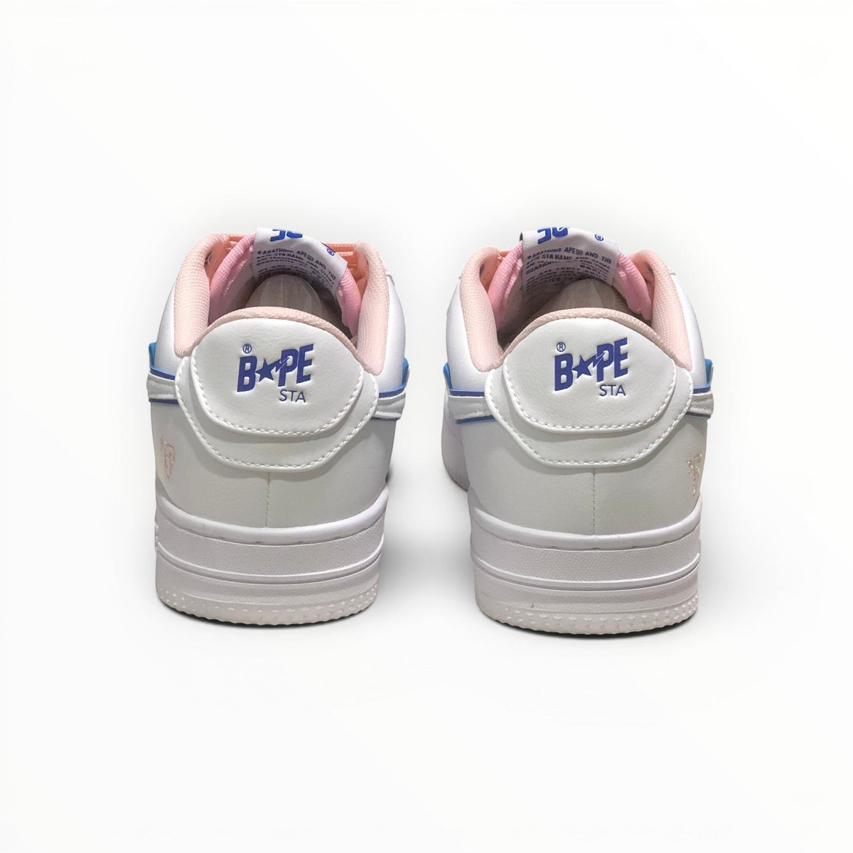 A Bathing Ape BAPE STA men's low-top sneakers in White/Peach, rear heel view